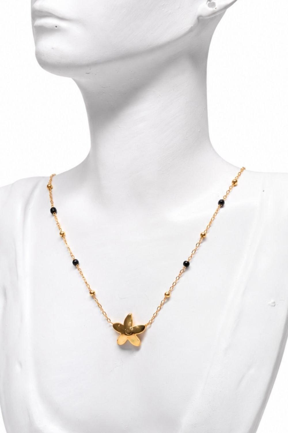 Fine lightweight graceful floral -inspired pendant complemented by subtle black and golden coloured bead accents necklace.