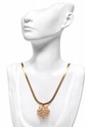 Gold-tone geometric pendant necklace.