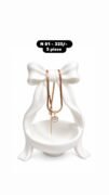Heart-shaped pendant with a pearl-like center and dangling chain necklace