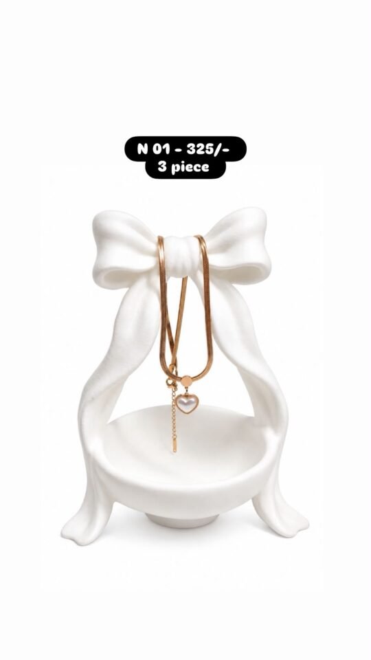 Heart-shaped pendant with a pearl-like center and dangling chain necklace