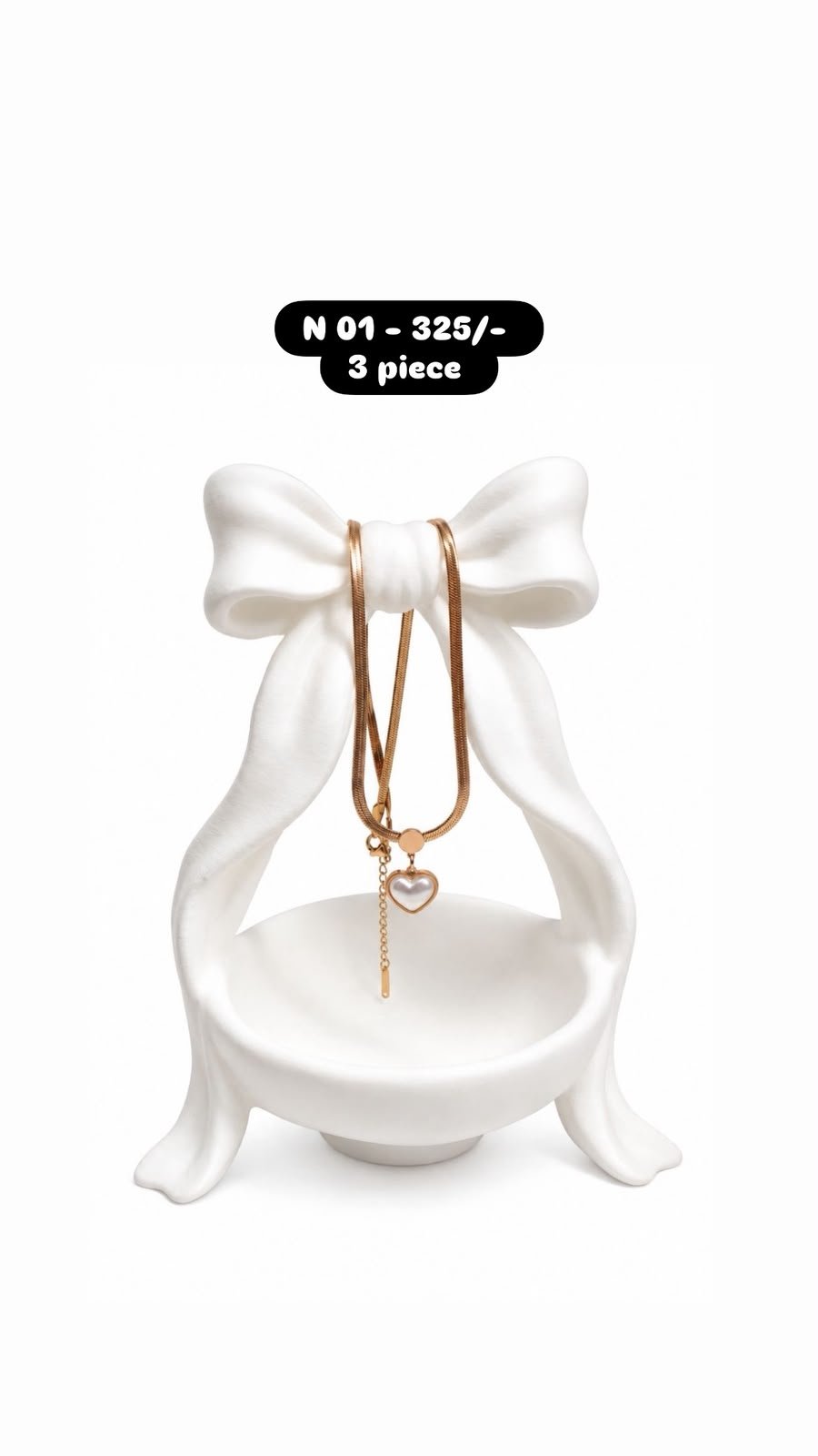 Heart-shaped pendant with a pearl-like center and dangling chain necklace